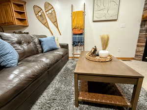 Living area with carpet and baseboards