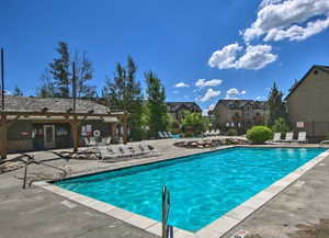 Community "heated" pool with a patio area and a residential view