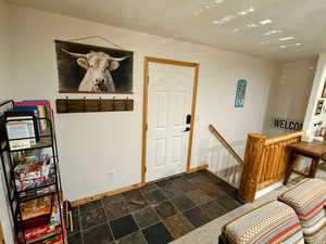 Foyer featuring baseboards and slate finish floors