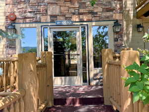 Doorway to property featuring stone siding