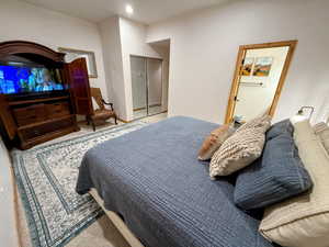 Daylight bedroom with carpet and recessed lighting and a smart TV