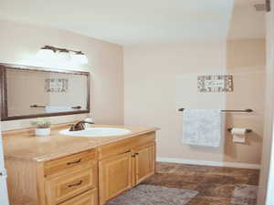 Bathroom with vanity and stone finish floors