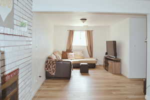 Living area featuring light wood finished floors and a fireplace