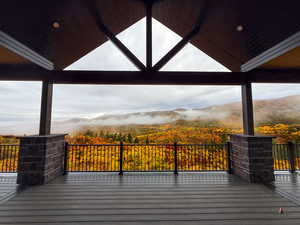 Wooden deck featuring a view of trees and a mountain view