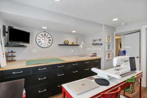 Kitchen featuring dark cabinets, light countertops, recessed lighting, and open shelves