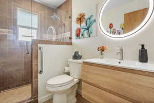Bathroom featuring a shower stall and vanity