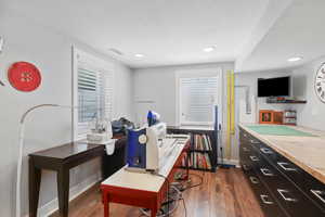Home office featuring dark wood-style flooring and recessed lighting