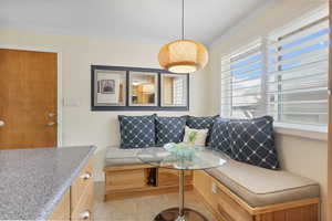 Built in breakfast nook with storage and ornamental molding