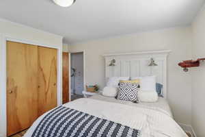 Bedroom featuring ornamental molding and a closet