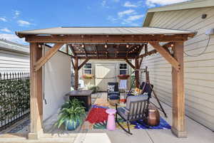 View of patio featuring a gazebo and a storage unit