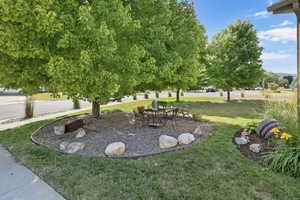 View of grassy yard featuring a patio area