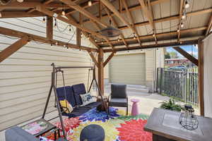 Wooden terrace featuring a patio area and a gazebo
