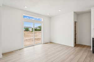 Unfurnished room with light wood-style flooring and recessed lighting