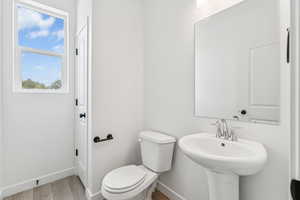 Bathroom featuring baseboards and wood finished floors