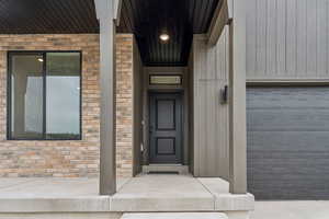 View of exterior entry featuring brick siding