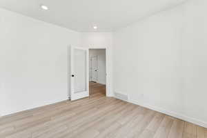 Unfurnished room featuring light wood-type flooring and recessed lighting