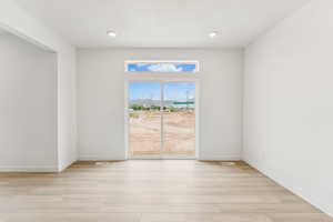 Spare room with light wood finished floors and baseboards