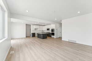 Unfurnished living room with recessed lighting and light wood finished floors