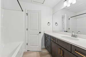 Full bathroom with vanity, wood finished floors, and  shower combination