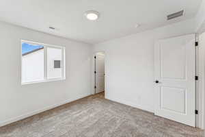 Unfurnished bedroom featuring carpet and baseboards