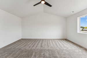 Unfurnished room with carpet floors, a ceiling fan, and lofted ceiling