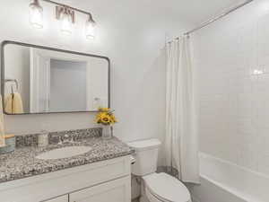 Full bath featuring vanity and shower / bath combo