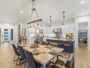 Dining space with light wood-type flooring and recessed lighting