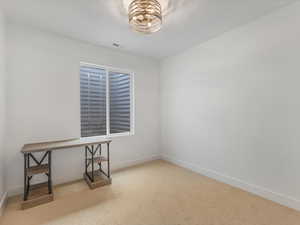 Carpeted empty room featuring baseboards