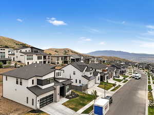Aerial perspective of suburban area with a mountainous background
