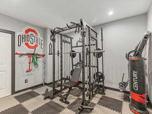Workout area with baseboards and recessed lighting
