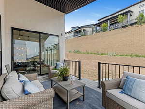View of patio with outdoor lounge area and a wooden deck