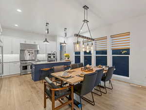 Dining room with recessed lighting and light wood-style floors