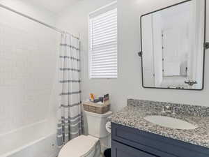 Bathroom with vanity and shower / bath combo