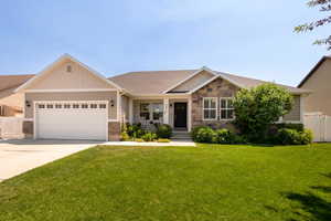 Craftsman inspired home featuring stone siding, a garage, driveway, and a shingled roof
