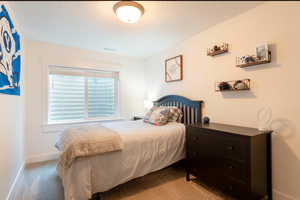 Carpeted bedroom featuring baseboards