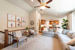 Living area featuring recessed lighting, lofted ceiling, light colored carpet, and ceiling fan