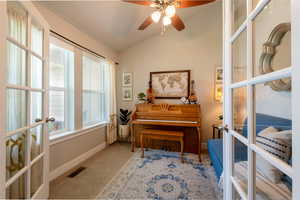 Sitting room with french doors, lofted ceiling, ceiling fan, and carpet flooring