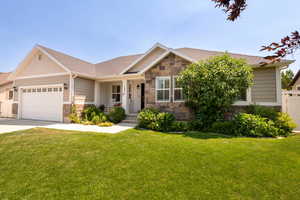 View of front of property with stone siding, an attached garage, concrete driveway, and roof with shingles