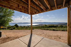 View of patio / terrace with a water and mountain view
