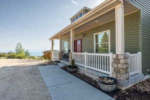 View of exterior entry featuring covered porch