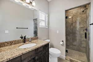 Masterbath bath featuring a stall shower, vanity, and tile patterned floors