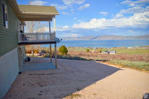 North View of yard featuring a water and mountain view and a patio
