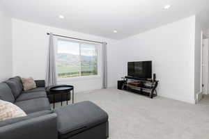 Living area featuring carpet and recessed lighting