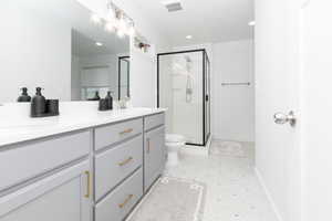 primary bathroom with a walk-in closet and soaker tub