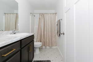 Full bath featuring vanity, tile patterned floors, and shower / bath combo with shower curtain