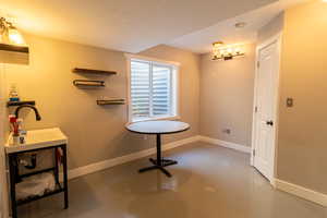 Bathroom with finished concrete floors and baseboards