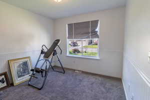 Exercise area with carpet floors and wainscoting