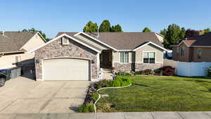 View of front facade with stone siding, concrete driveway, an attached garage, stucco siding, and a shingled roof