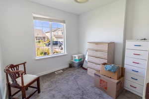 Living area with carpet and baseboards