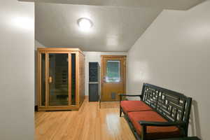 Room with sauna and door to large deck.